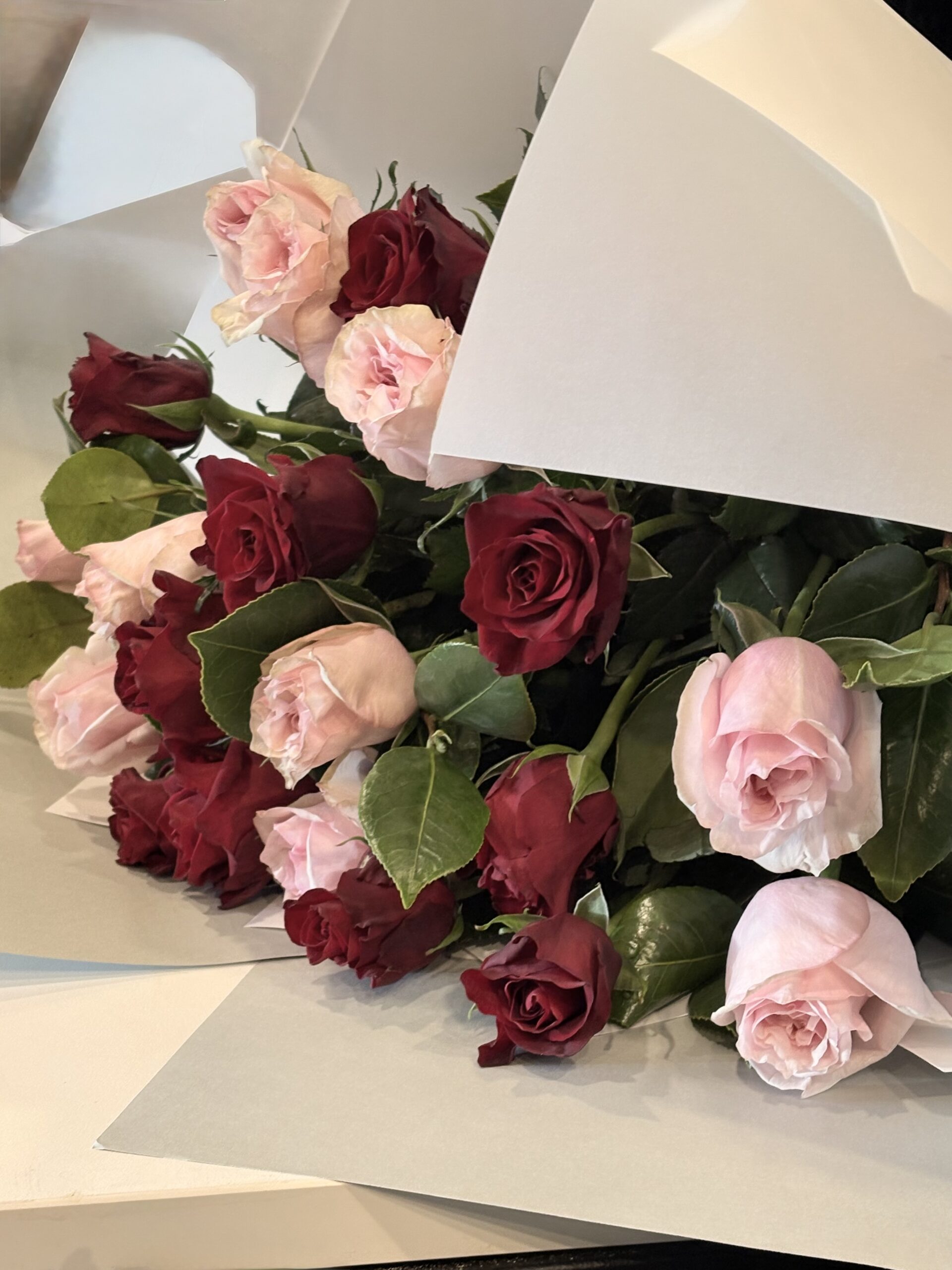 Rosy Cheeks A mix of 10 Medium Stem Pink Roses and 10 Med Stem Red Roses Foliage Signature wrap $166